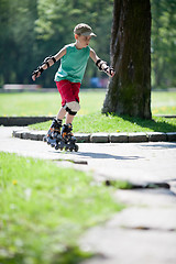 Image showing Little boy on rollerblades