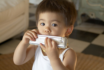 Image showing Anael playing harmonica