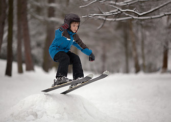 Image showing Little boy skier jumping