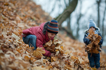 Image showing Children playing with the leaves