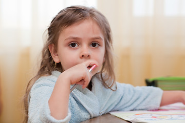 Image showing Little girl with pencil