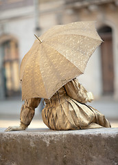 Image showing Live statue under umbrella