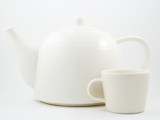 Image showing stylish white porcelain teapot and cup 