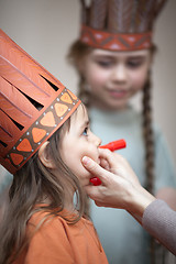 Image showing Little girls preparing to play Indians