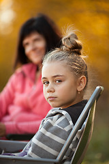 Image showing Pretty young girl and mom in background