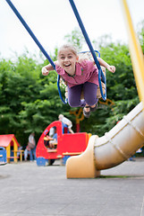 Image showing Girl swinging and laughing