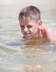 Image showing Little boy in the sea