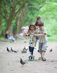 Image showing Riding a scooter in a park