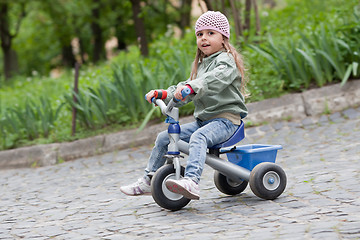 Image showing Little girl ( 4-5) on tricycle