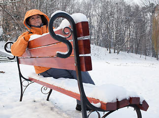 Image showing Woman on snowy bench