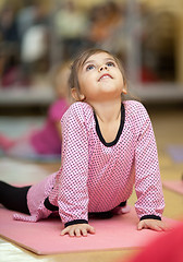 Image showing Little girl stretching