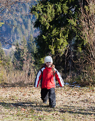 Image showing Little girl walking in autumn forest