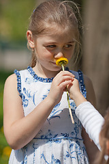 Image showing Teenager girl sniffing flower