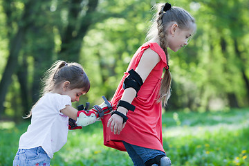 Image showing Sisters skating in park