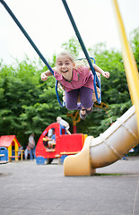 Image showing Girl swinging and laughing