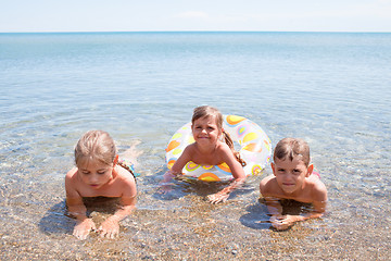 Image showing Three children in the sea