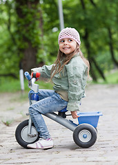 Image showing Little girl ( 4-5) on tricycle