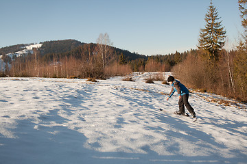 Image showing Climbing up on skis