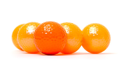 Image showing Orange and golden golf balls