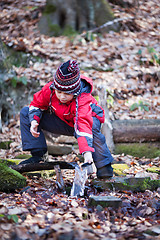 Image showing Child taking water from spring