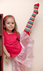 Image showing Little girl doing stretching
