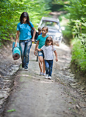 Image showing Hikers walking through forest