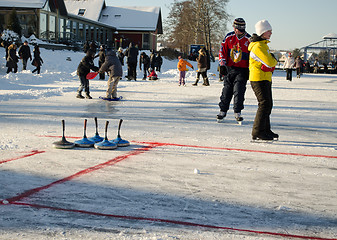 Image showing people play curling eisstock skate frozen lake ice 