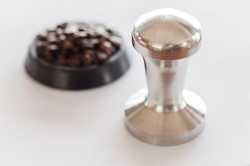 Image showing Coffee tamper and middle roasted coffee bean 