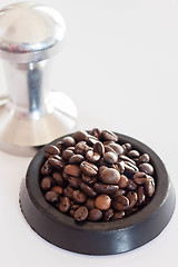Image showing Middle roasted coffee bean in rubber saucer