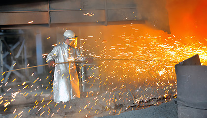 Image showing mill worker with hot steel