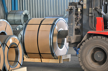 Image showing Forklift with rolls of steel sheet