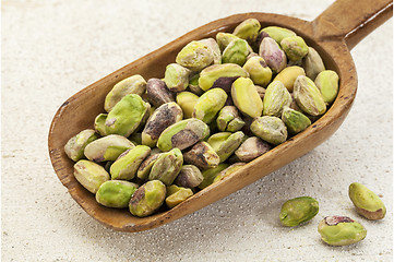 Image showing raw pistachio nuts on a scoop