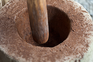 Image showing Grinding cocoa beans in the mortar