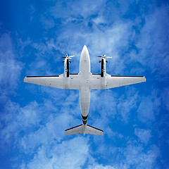 Image showing Bottom view - twin prop airplane on sky background