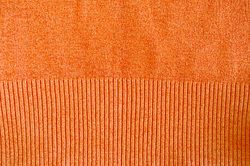 Image showing orange knitted wool sweater closeup background 