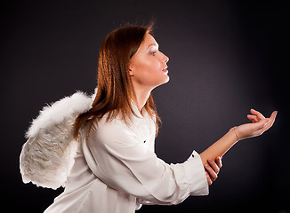Image showing young sexy woman with angel wings calling