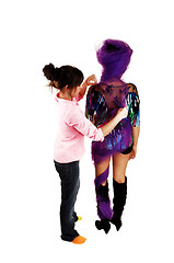 Image showing Girl fixing up model.