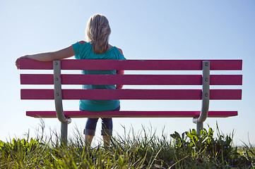 Image showing Woman sitting on bench
