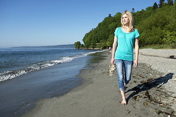 Image showing Woman walking on beach