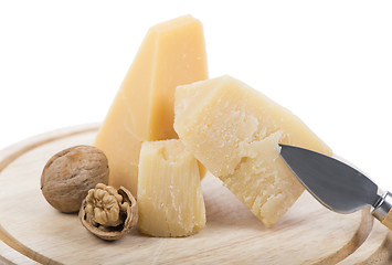 Image showing Nuts and cheese on wooden board.