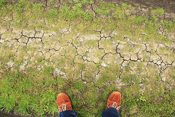 Image showing Orange boots on ground from above