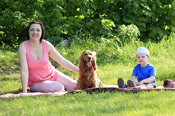 Image showing Mother, child and dog on picnic