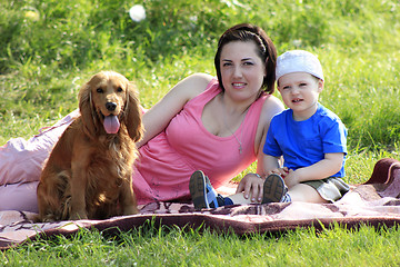 Image showing Mother, child and dog on picnic