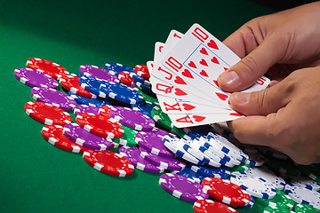 Image showing Colorful poker chips and royal flush