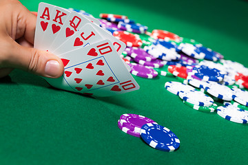 Image showing Colorful poker chips and royal flush