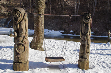 Image showing carved wooden rural design empty swing river snow 