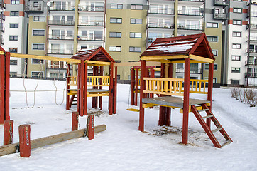 Image showing playground wooden red houses swing rope winter  