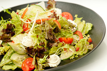 Image showing Healthy green salad on the black plate