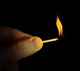 Image showing Hand holding burning match stick