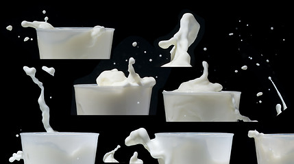 Image showing Splashing milk black isolated